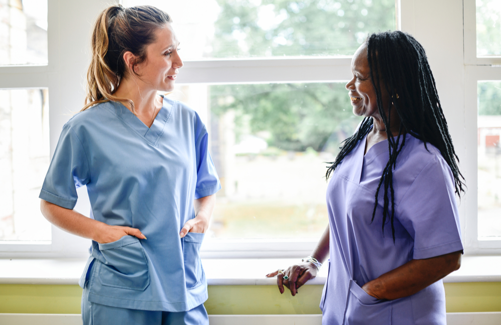 Nurses in scrubs chatting – part of one of the fastest growing industries